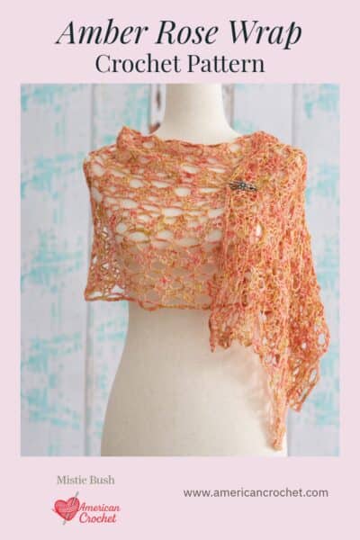 Amber Rose Wrap crochet pattern Pinterest pin — romantic open lace mesh wrap in warm peachy coral on dress form, by Mistie Bush of American Crochet