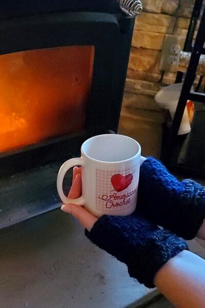 Cozy fireside crochet with a warm American Crochet mug - Crafting a Rainbow of Hope