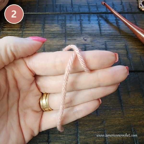 Step 2 - the yarn crossed into a loop to begin the crochet slip knot.