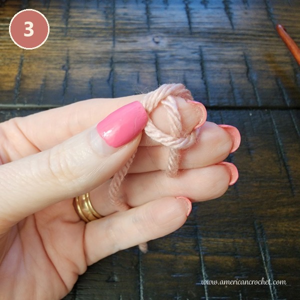 Step 3 - pulling the working yarn through the loop to form the slip knot.