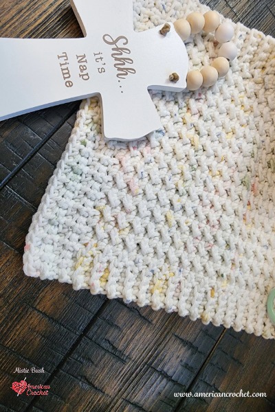 Close-up of the textured crochet stitches on Sophie's Little Blessing Lovey beside a Shhh It's Nap Time sign.